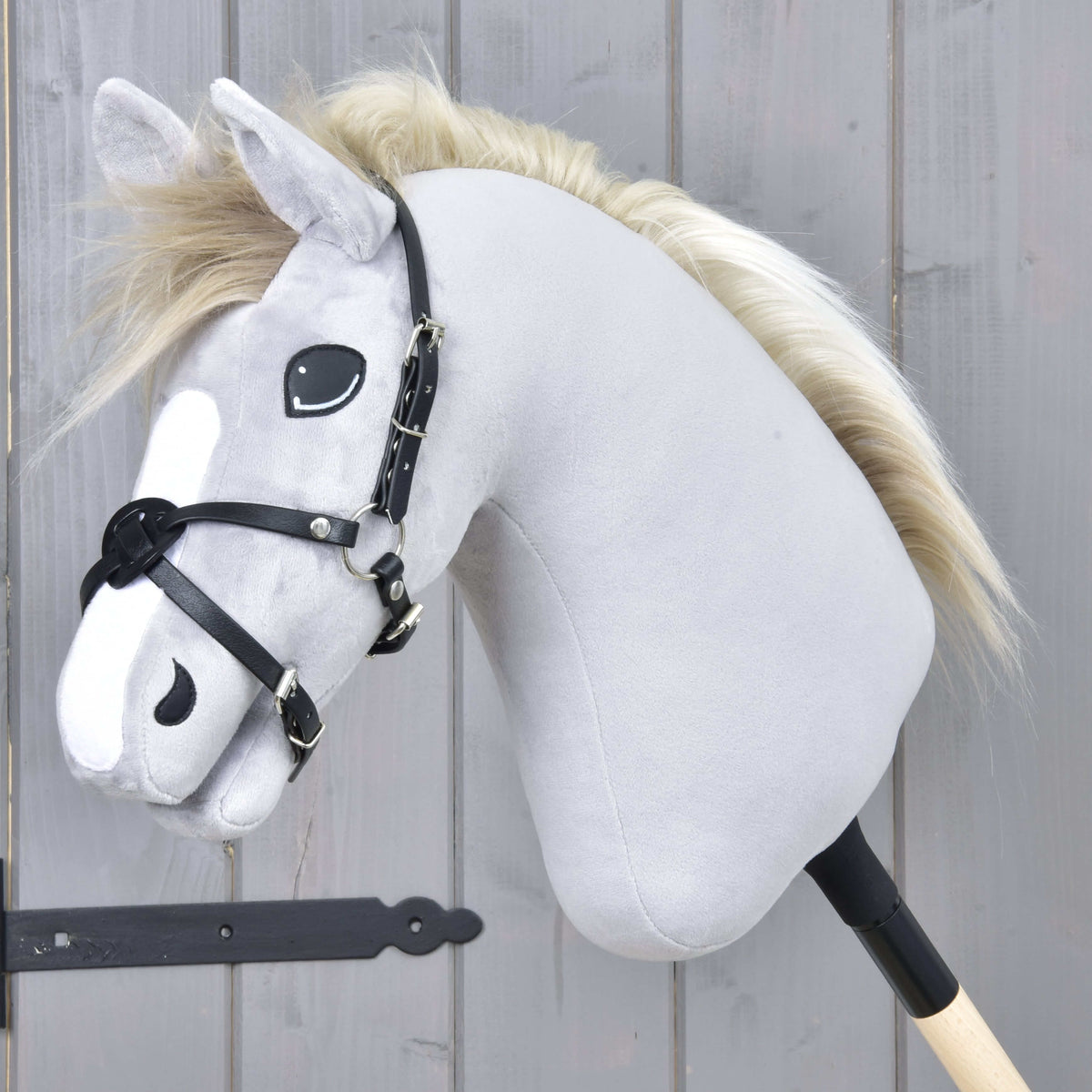 Hobby Horse Neusriem Mexico zwart van LarDen van zwart kunstleer, gekruist over de neus van een grijs pluche hoofd