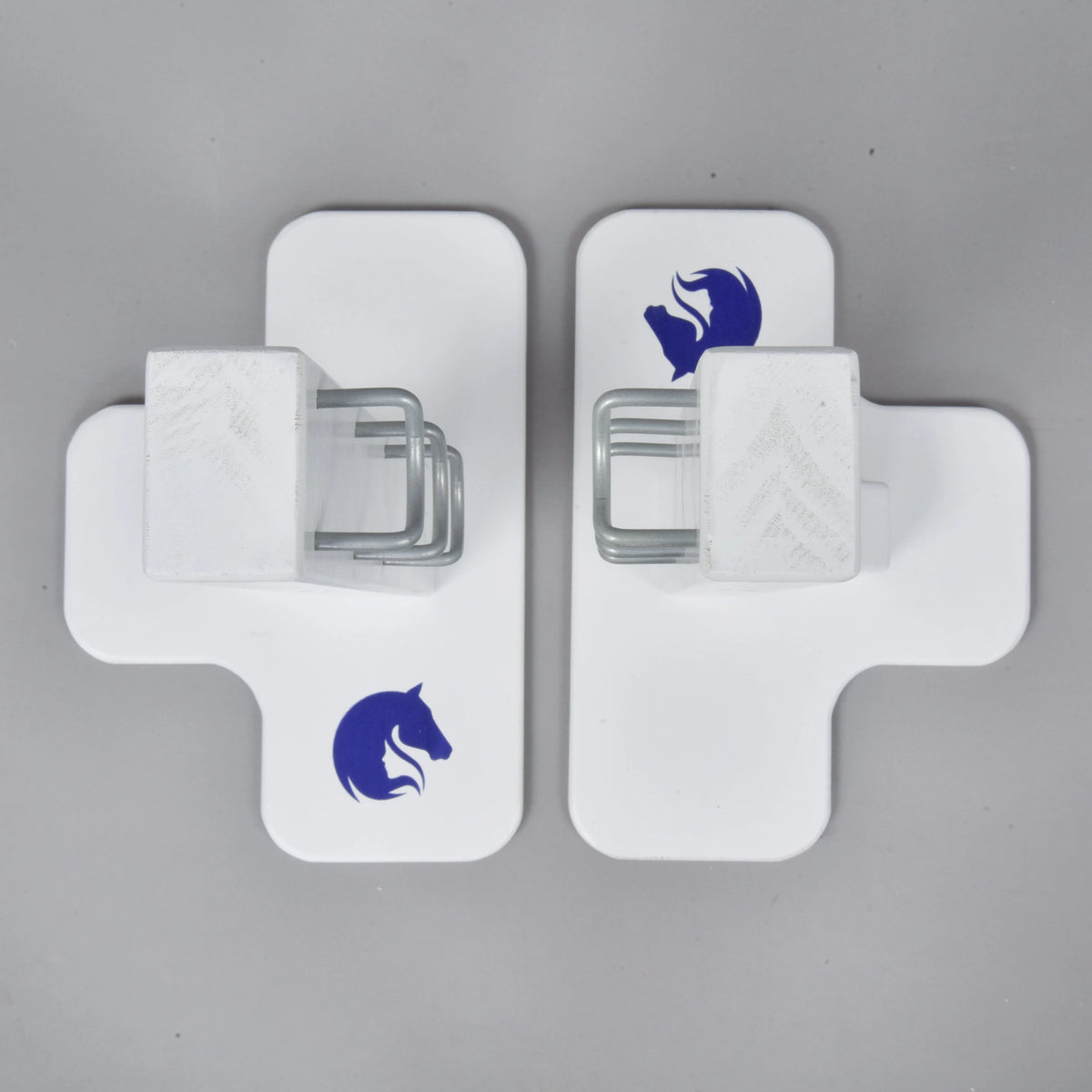 Top view of the two white cross-shaped feet with blue horse head logos and the metal hooks on the stands