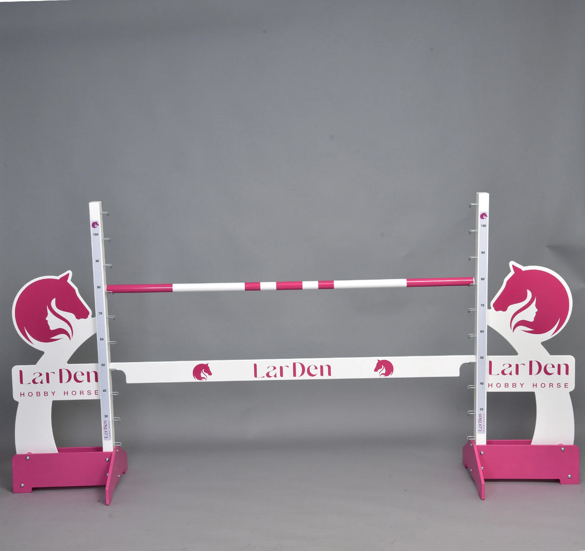 Hobby Horse LarDen jump with pink horse head wings, pink feet, a pink and white pole and a white filler board