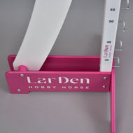 Close-up of a pink foot with white LarDen Hobby Horse lettering, holding the post marked from 30 to 55 cm