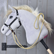Grey Hobby Horse in a black halter with the sand Western Reins Dakota clipped on and looped over its neck