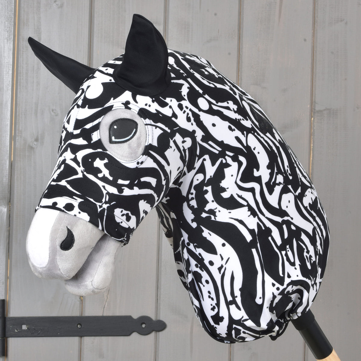 Hobby Horse protective suit Black & White by LarDen in a swirling black and white print with black ears, on a grey plush head