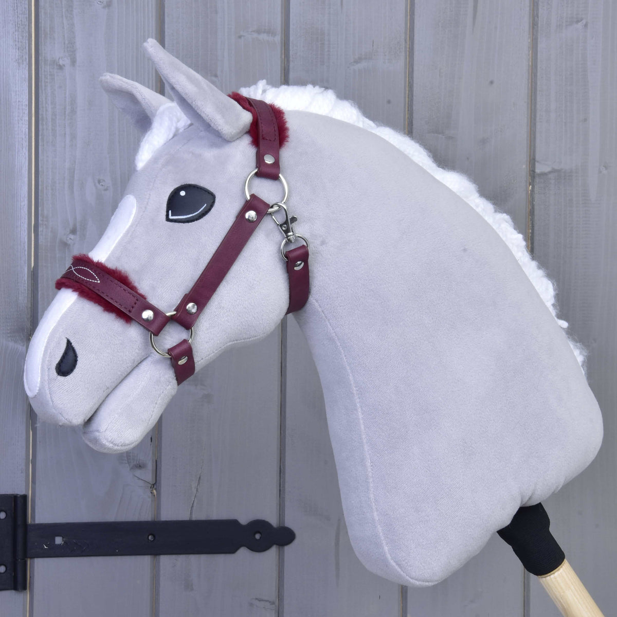Light grey Hobby Horse with white mane wearing the burgundy leatherette halter with fur on noseband and crownpiece