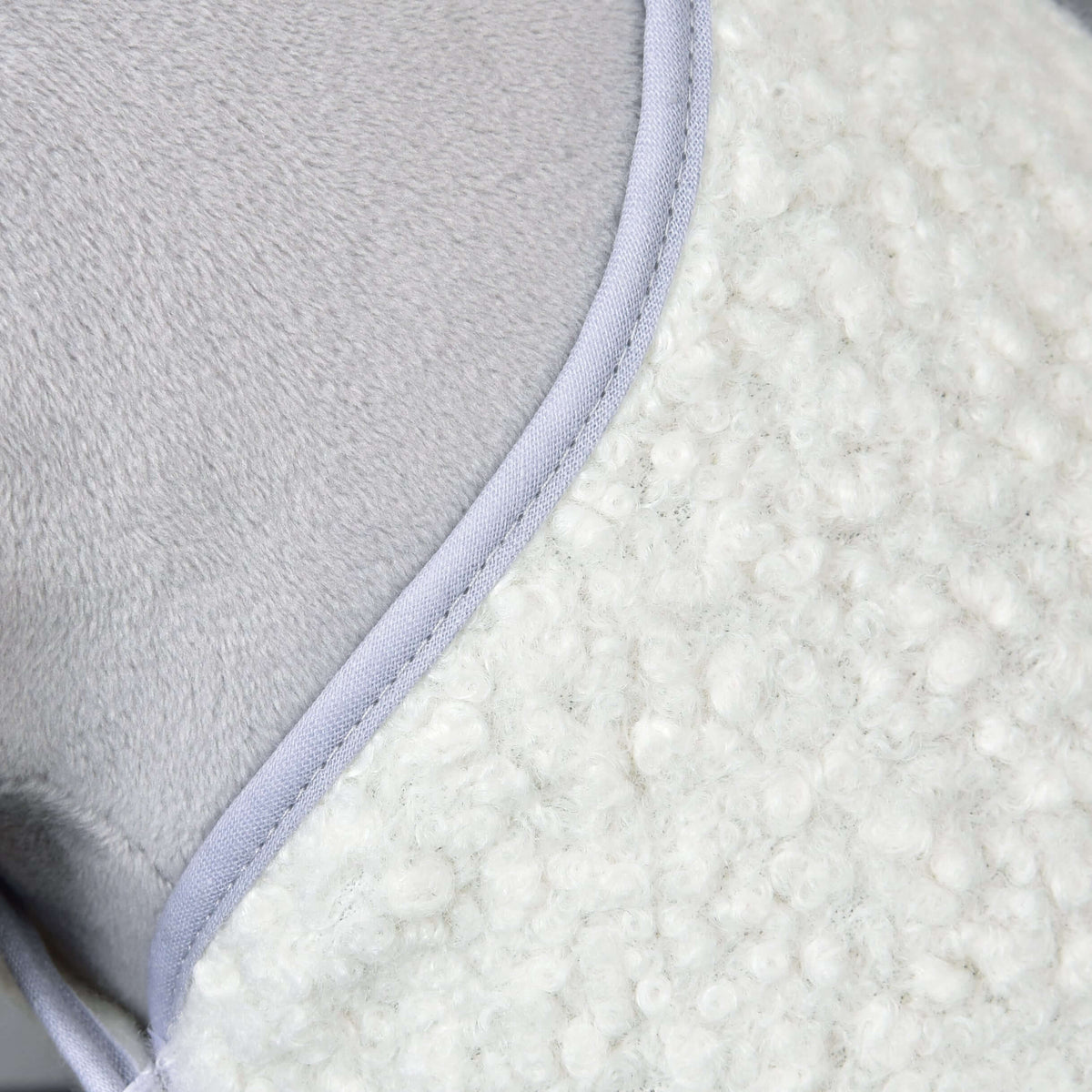 Detail of the Hobby Horse Set Snowflake: curly cream bouclé fleece edged with grey binding against the grey plush neck