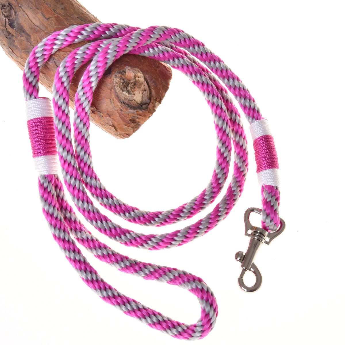 Hobby Horse lead rope from the Set Start Pink in pink and grey twisted rope with white whipping and a snap hook, on a branch
