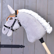 A grey plush Hobby Horse with a white braided mane and black halter wears the brown houndstooth ear bonnet