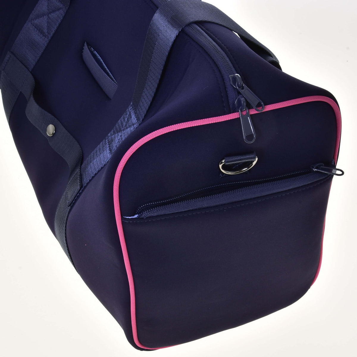 End of the navy Hobby Horse Sports bag with pink piping, a zipped compartment and a metal D-ring for the strap