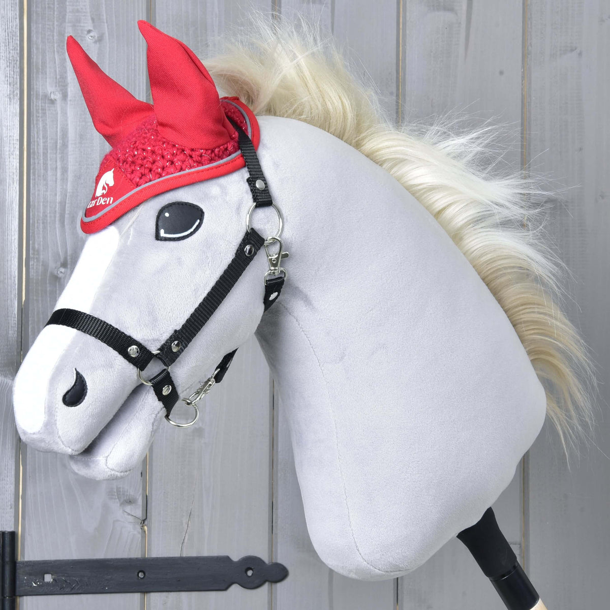 Grey Hobby Horse with a blond mane and black halter wearing the Ear bonnet crocheted Red Sport in bright red