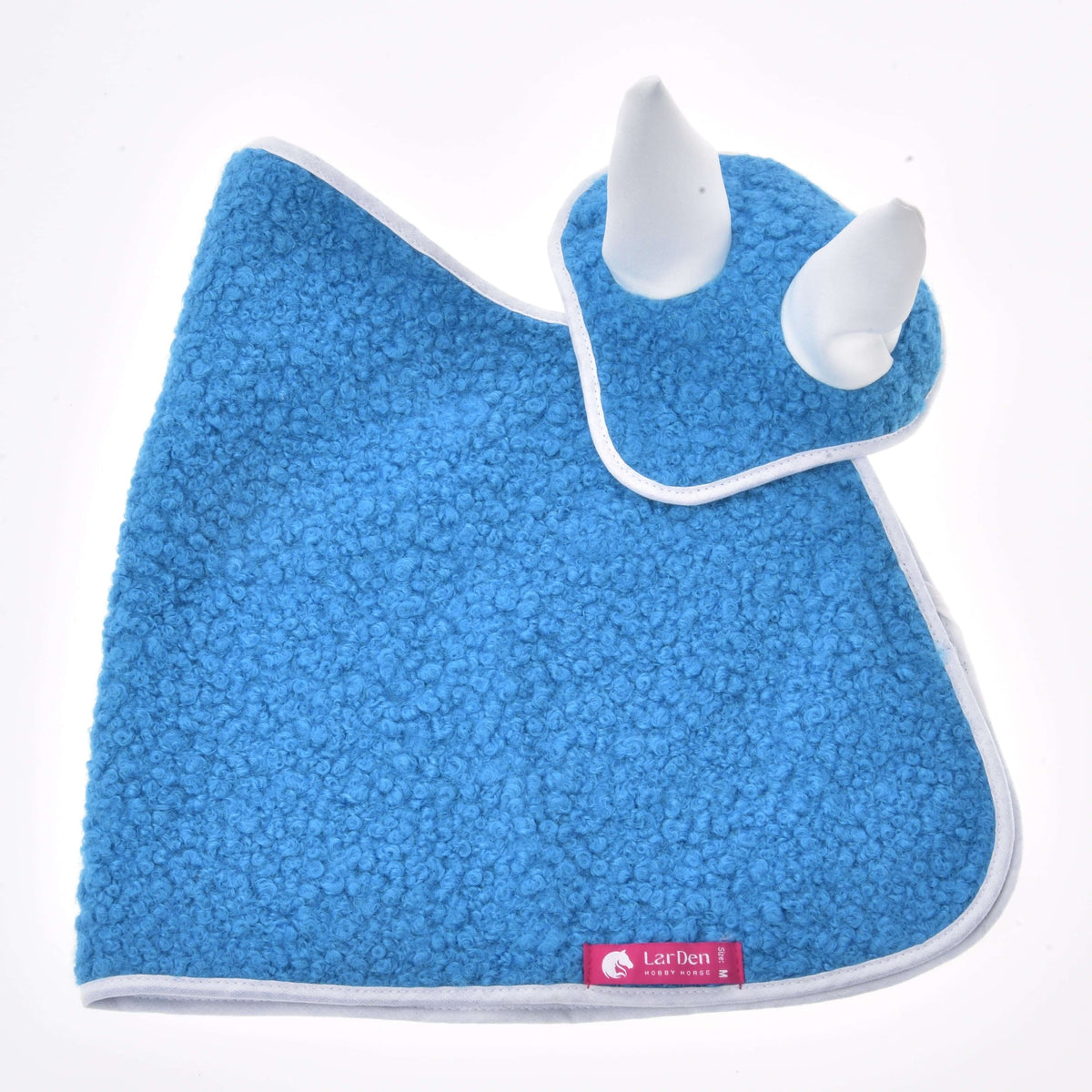 The blue curly blanket and ear bonnet laid flat from the side without the heart, with a pink LarDen label at the hem