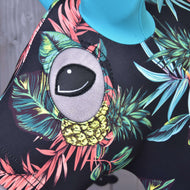 Close-up of the eye opening above a yellow pineapple on the black Pineapple protective suit worn by a Hobby Horse
