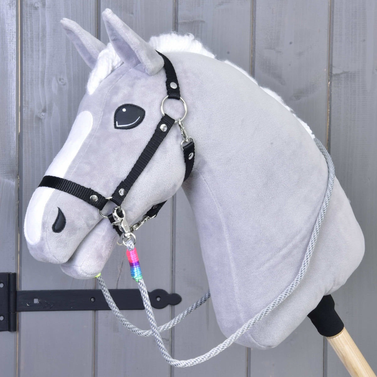 Grey plush Hobby Horse with a black halter and grey Manhattan rope reins with a rainbow wrap at the clip
