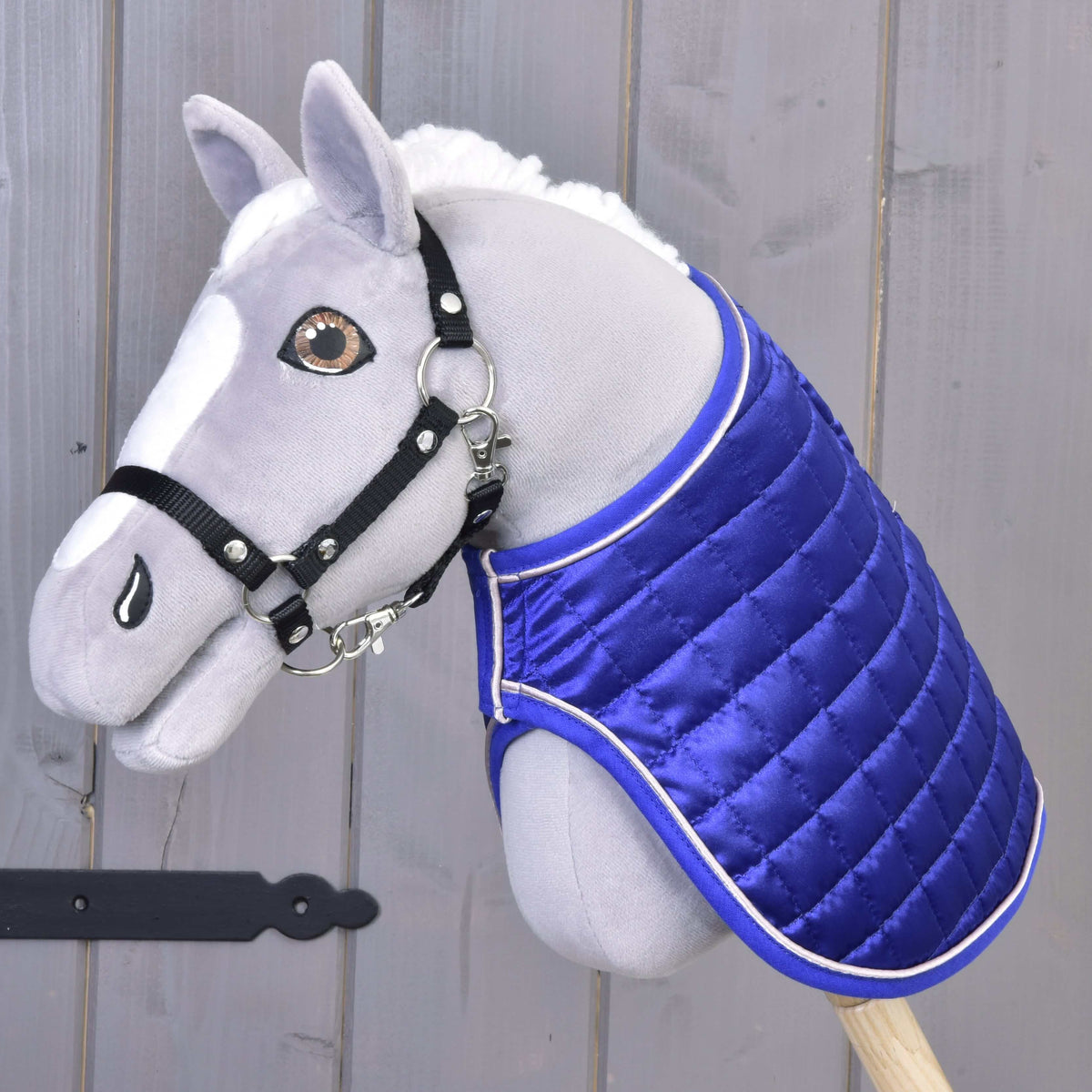 Grey Hobby Horse with amber eyes and black halter wearing the Blanket DeLuxe Blue with the glossy royal blue side out