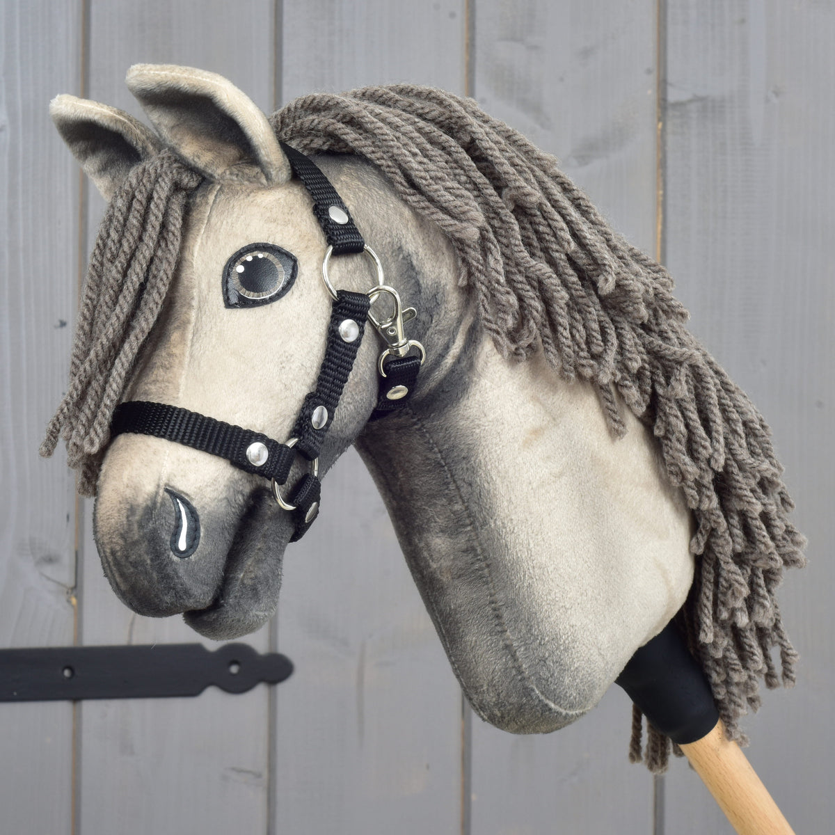 Hobby Horse Dusty by LarDen, a pale grey-beige plush head with dark shading, grey-brown yarn mane and black halter