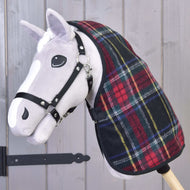 Grey Hobby Horse in a black halter wearing the red tartan stable blanket with green, blue and yellow checks