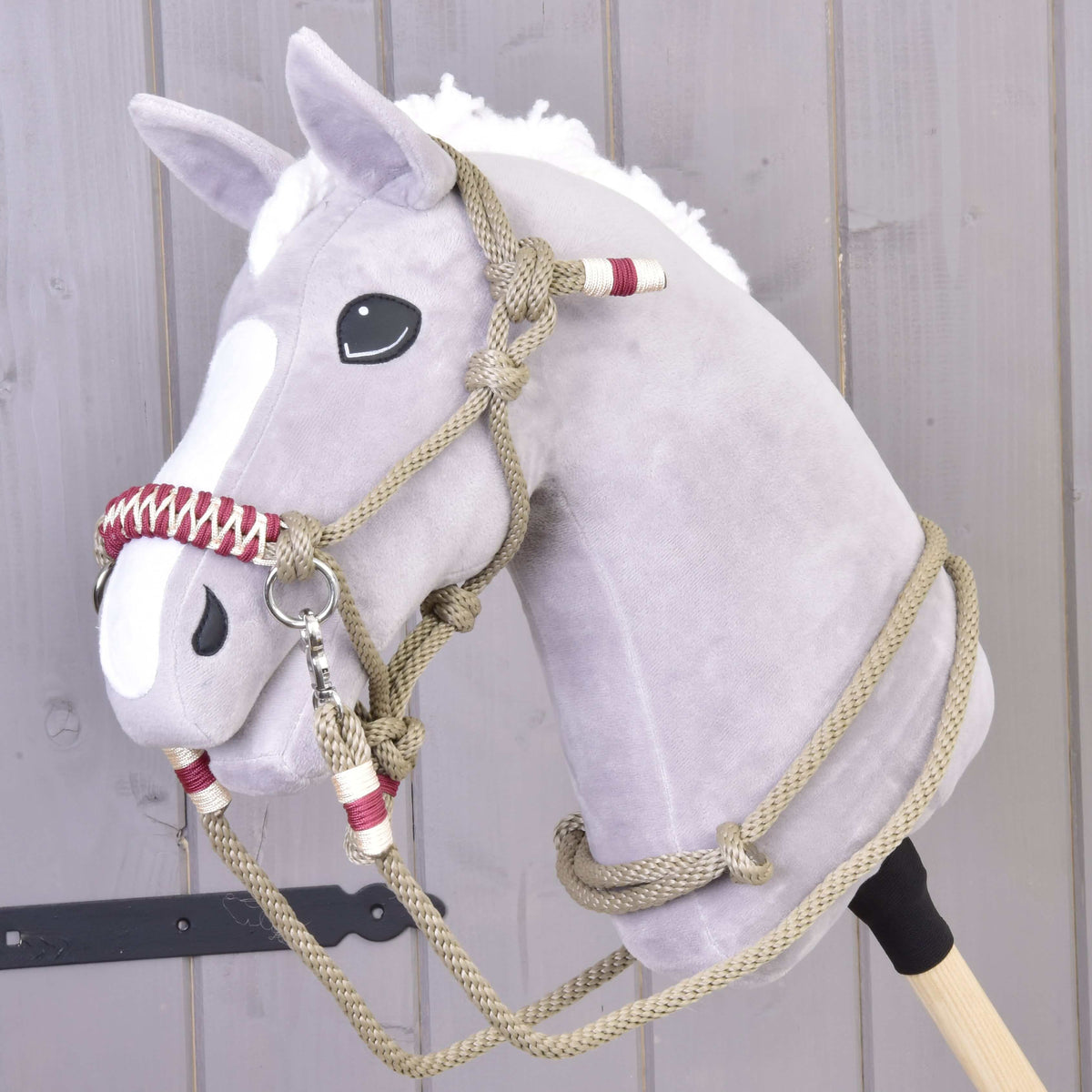 Grey Hobby Horse with a white blaze wearing the Rope set Eleganza, a beige rope halter and reins with burgundy wraps