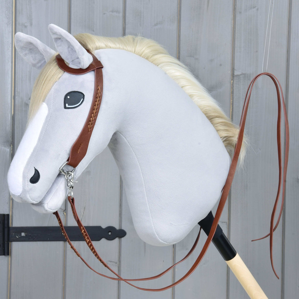 Hobby Horse Complete Western bridle One-Ear by LarDen in brown with long split reins, on a grey plush head