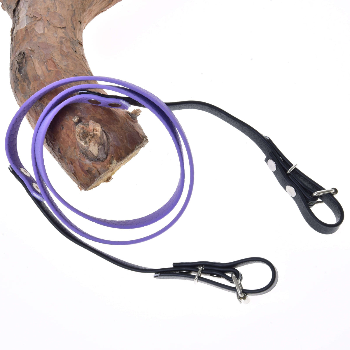 Hobby Horse Reins rubberized Light purple by LarDen, lilac middle and black buckle ends, looped over a pine branch