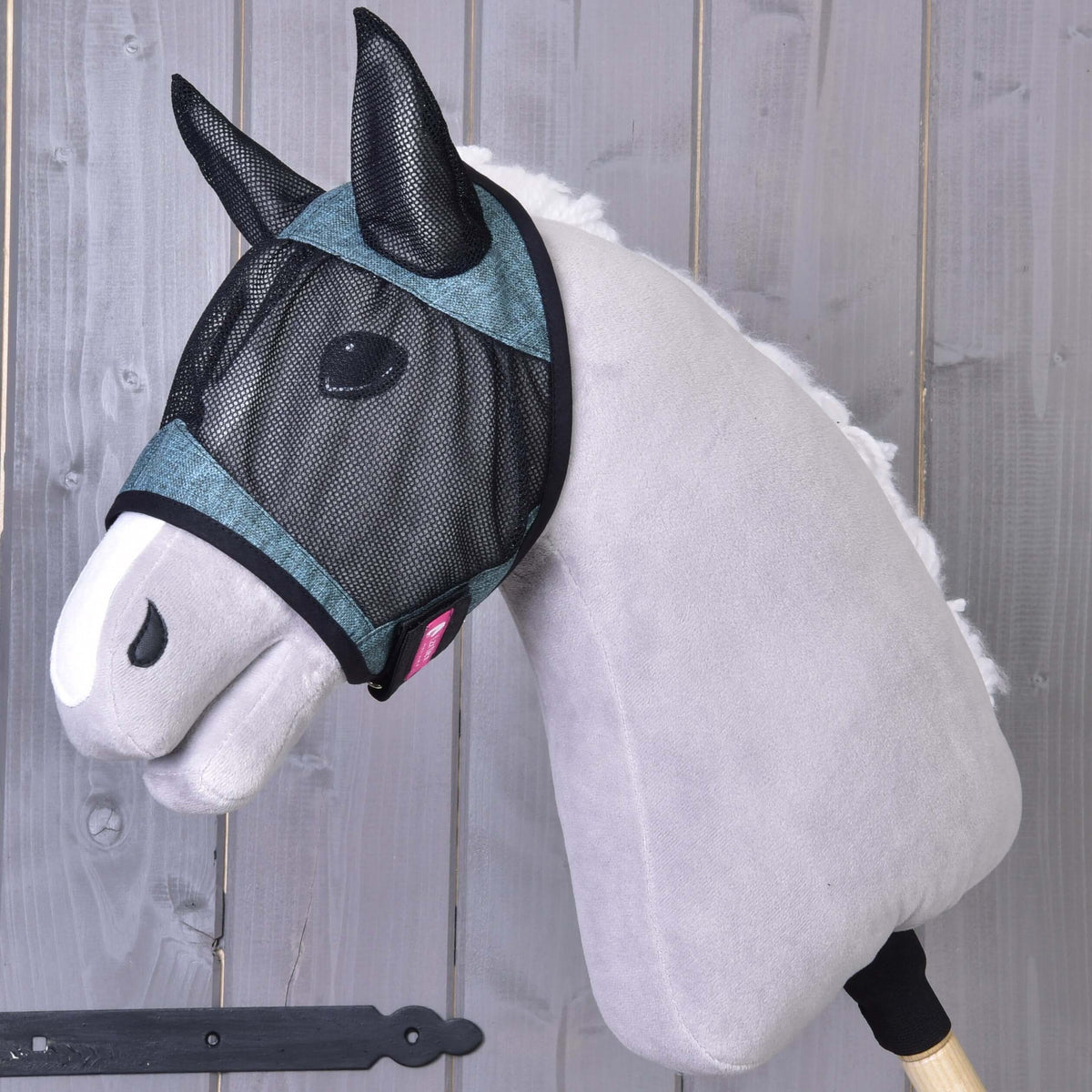 Hobby Horse Fly Mask De Luxe Turquoise by LarDen, heathered turquoise fabric with black mesh, on a grey plush head