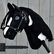 Hobby Horse Merlin met zwart halster van LarDen, zwart pluche met witte bles en vlekken en lange zwarte manen van garen