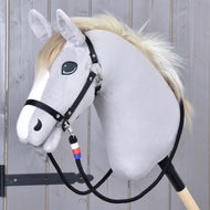 Teugels Emblem CZ op een grijze Hobby Horse met lichte manen en zwarte halster, de wit-rood-blauwe omwikkeling onder de kin