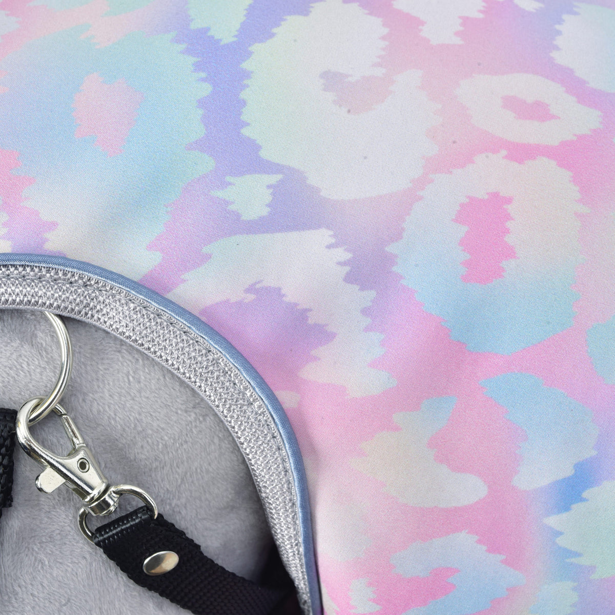 Detail of the pastel leopard print of the Raincoat Pallette, silver binding with blue piping and a black halter snap hook