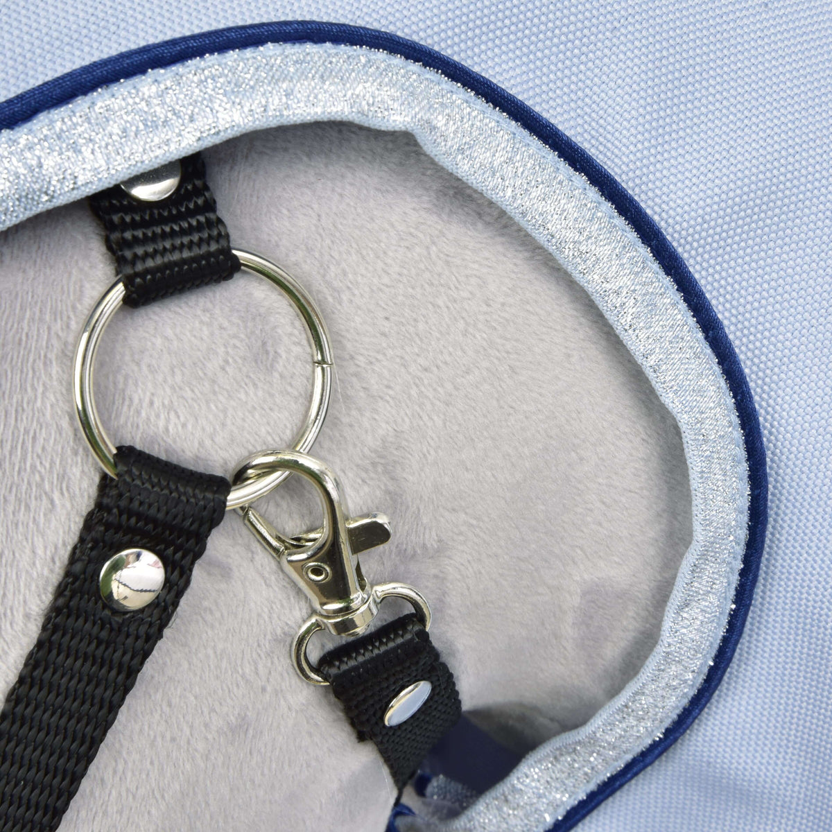 Close-up of the silver glitter binding and navy piping around the face opening, with the black halter ring and clip