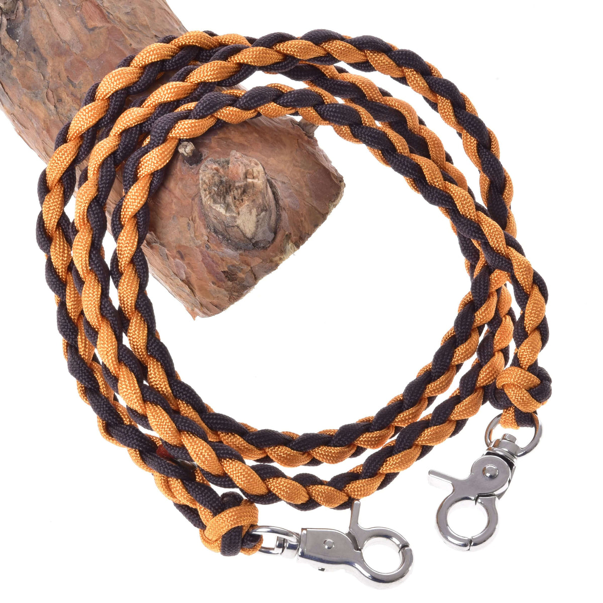 Hobby Horse Reins Knitted Pomello by LarDen, braided orange and dark brown cord with two snap hooks, on a branch