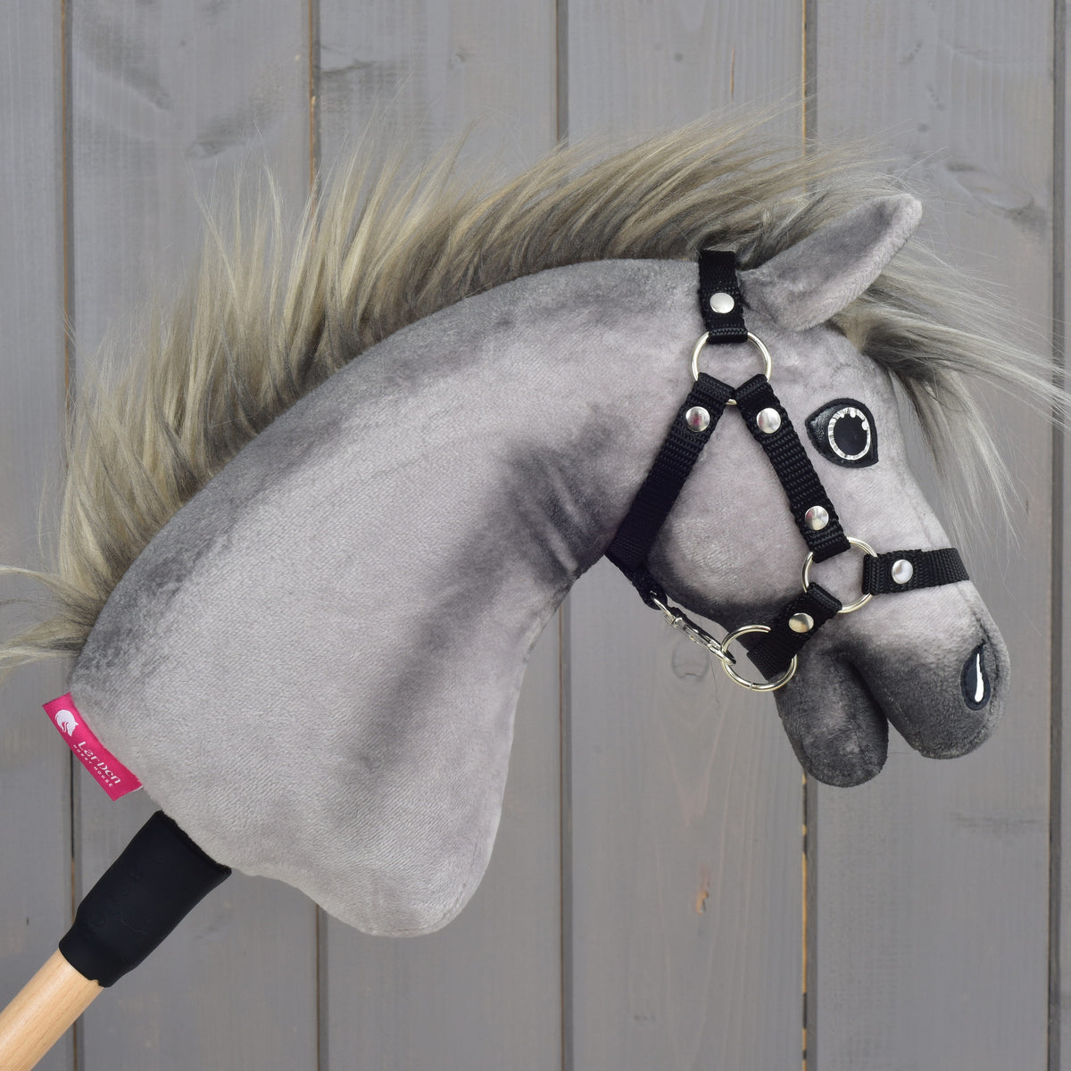 Hobby Horse Prestige facing right with the pink LarDen label on the grey neck and a wild grey-blond mane