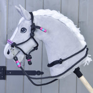 Grey Hobby Horse wearing the Rope set Princess: black rope halter and reins with pink and turquoise wraps