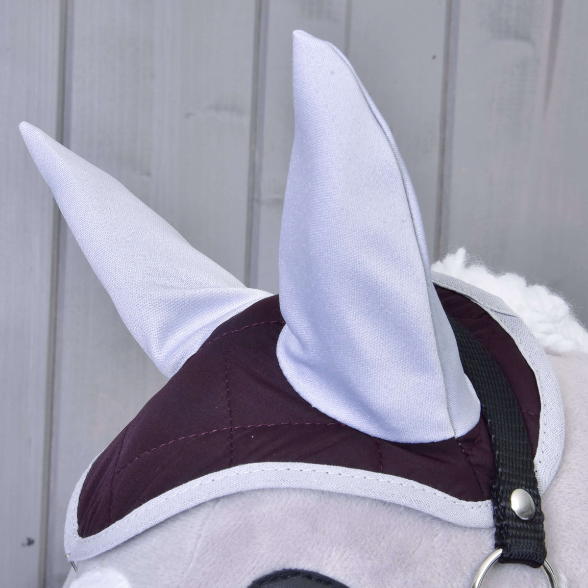 Close-up of the Set Purple ear bonnet with dark purple quilting and light grey ears on a Hobby Horse