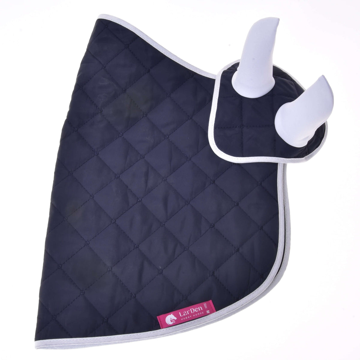 Hobby Horse Set Monte laid flat on white, navy quilted outer side with white binding and a pink LarDen label at the hem