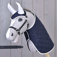Grey Hobby Horse with black halter wearing Set Monte, the navy quilted blanket and ear bonnet edged in white