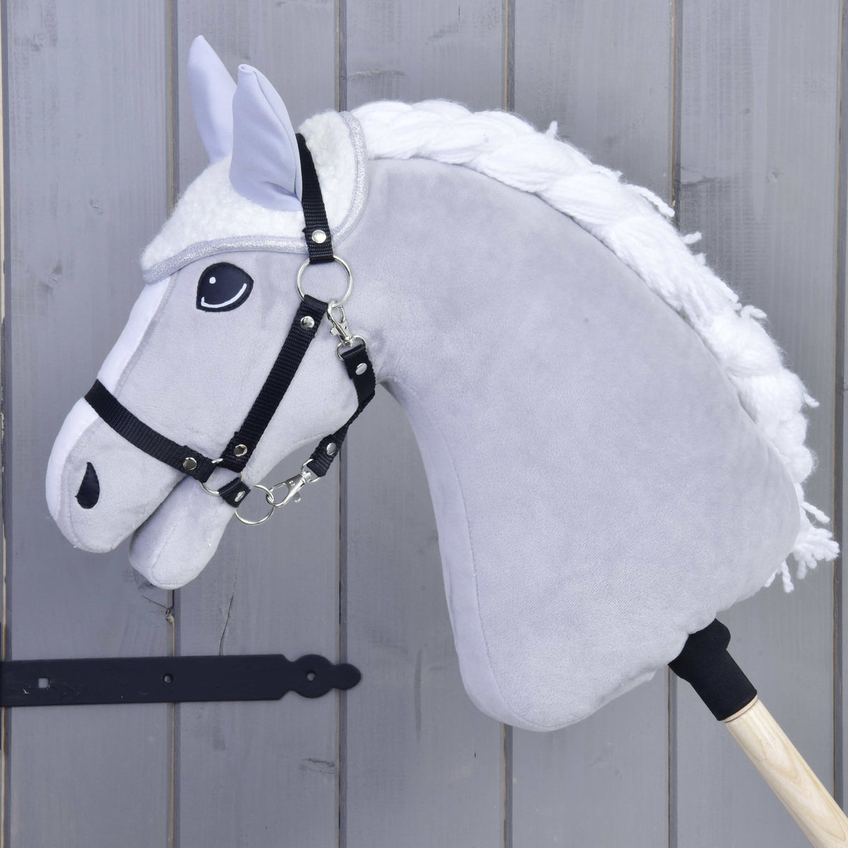 Grey Hobby Horse with a black halter wearing only the Set Snowflake ear bonnet, cream fleece with light grey ears