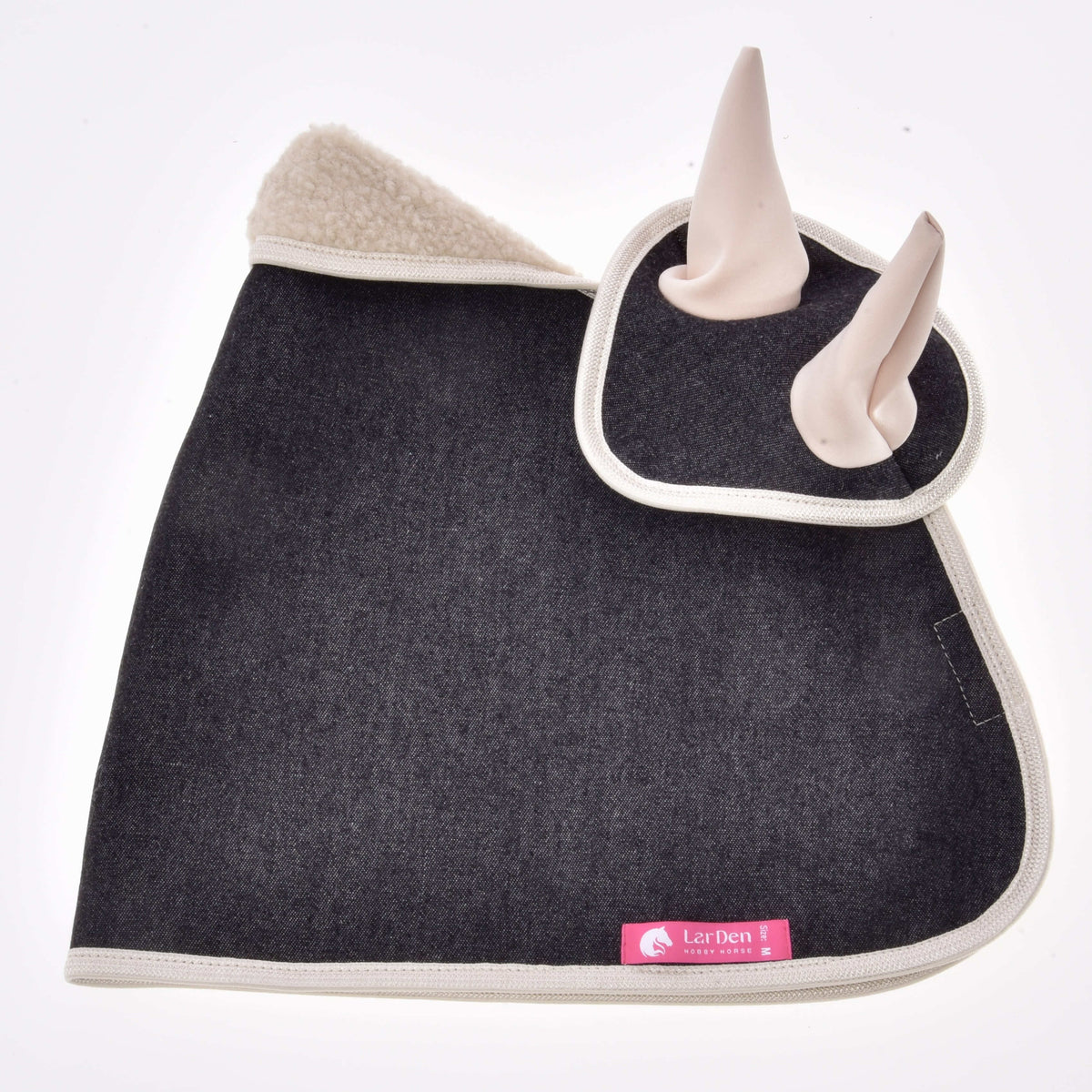 Dark denim blanket with the ear bonnet on top, fluffy beige sherpa collar, cream binding and pink LarDen label