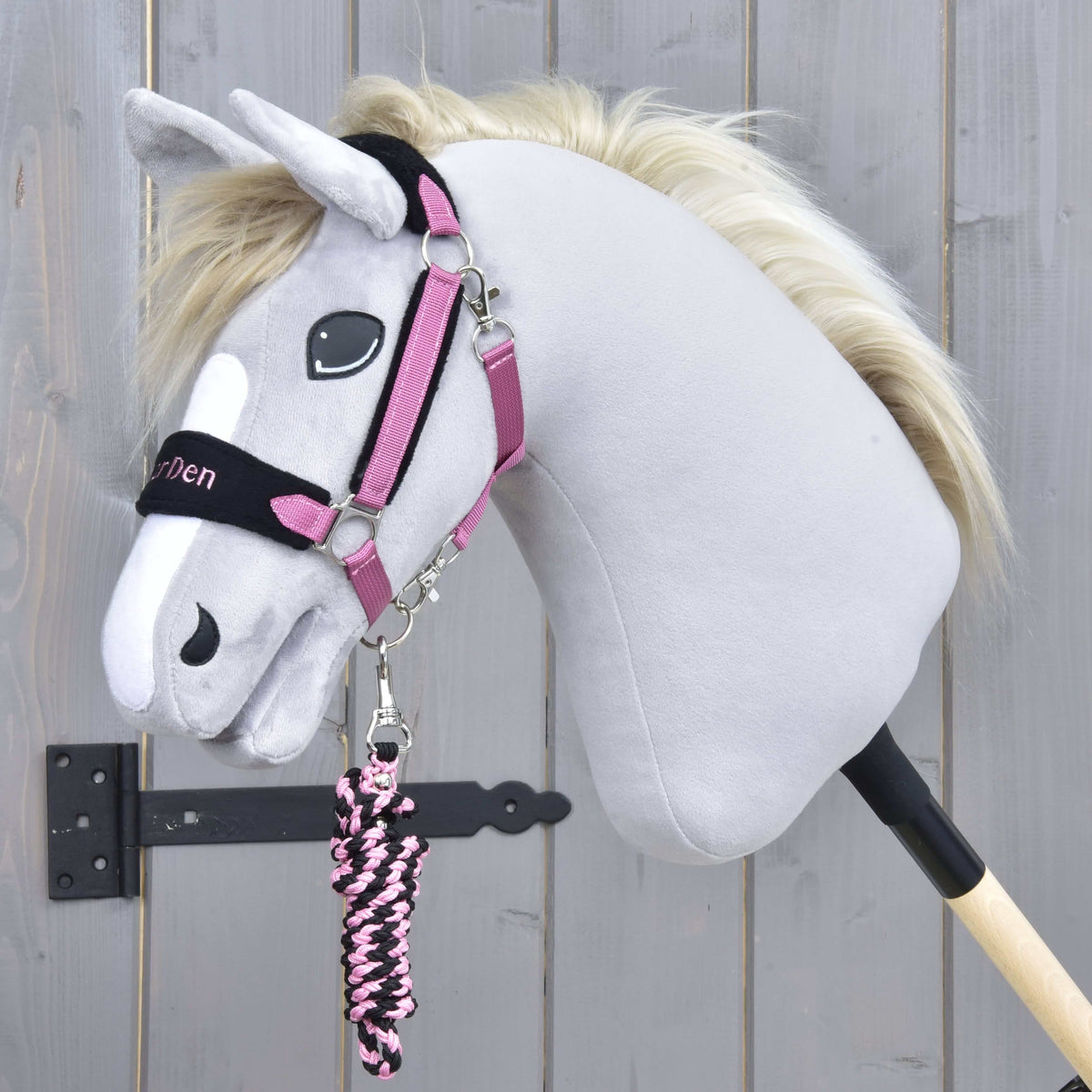 Halster Exclusive Pink op een grijze Hobby Horse met lichte manen, het gevlochten roze-zwarte halstertouw opgerold onder de kin