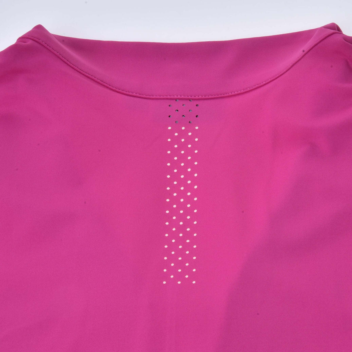 Back of the pink Hobby Horse T-Shirt below the collar, with a vertical strip of tiny ventilation holes