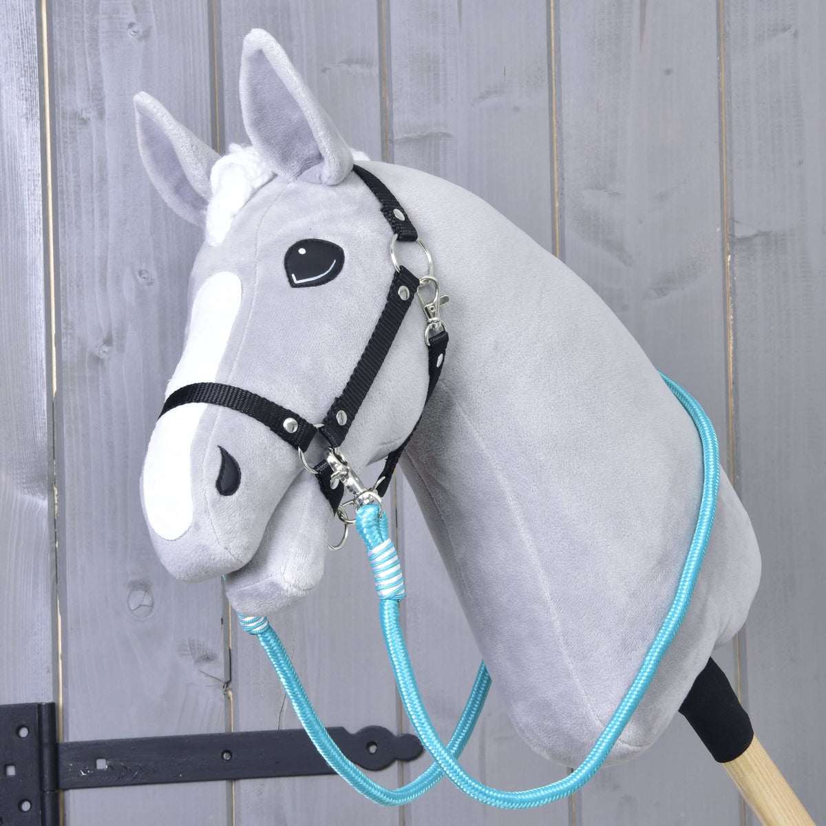 Lichtgrijze Hobby Horse met zwart halster en turquoise Teugels Atlantis om de hals