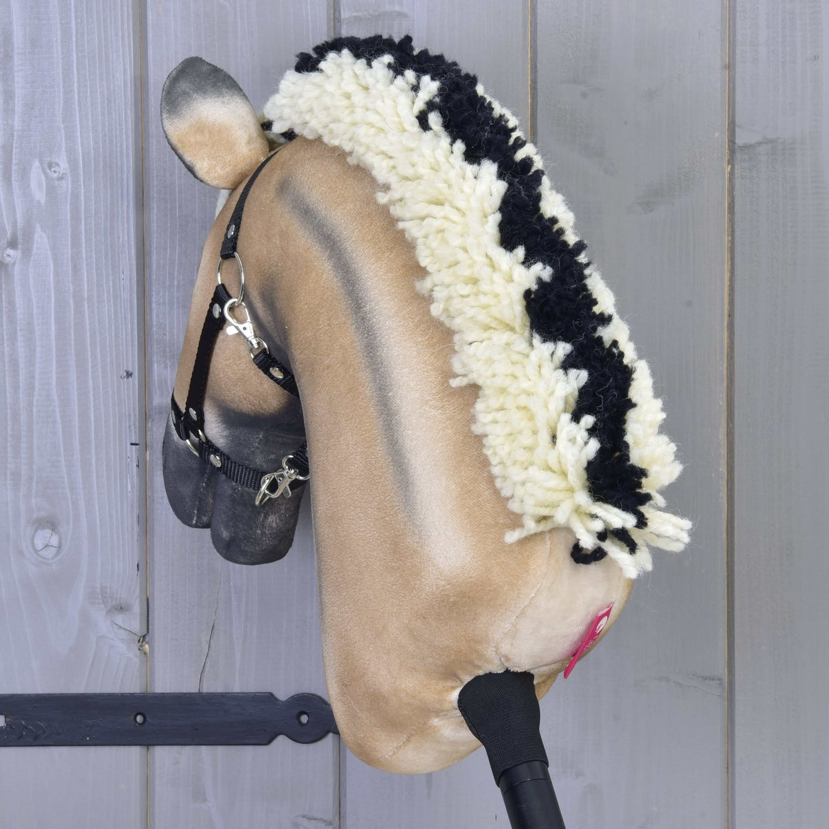 Hobby Horse Colby seen from the back, showing the black centre stripe running through the cream mane