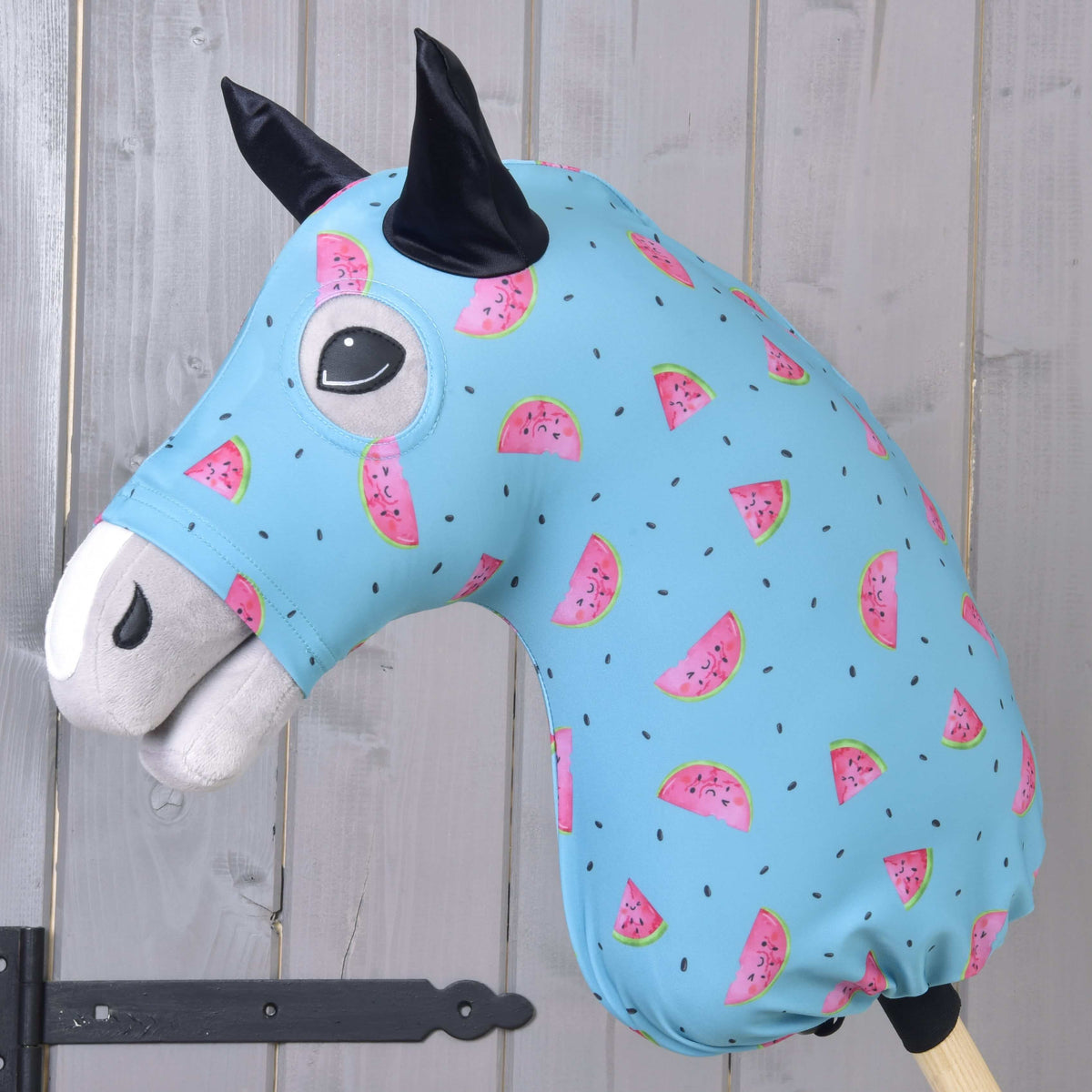 Hobby Horse beschermpak Melon (Lycra) van LarDen, lichtblauw met lachende watermeloenpartjes, over een grijs hoofd getrokken
