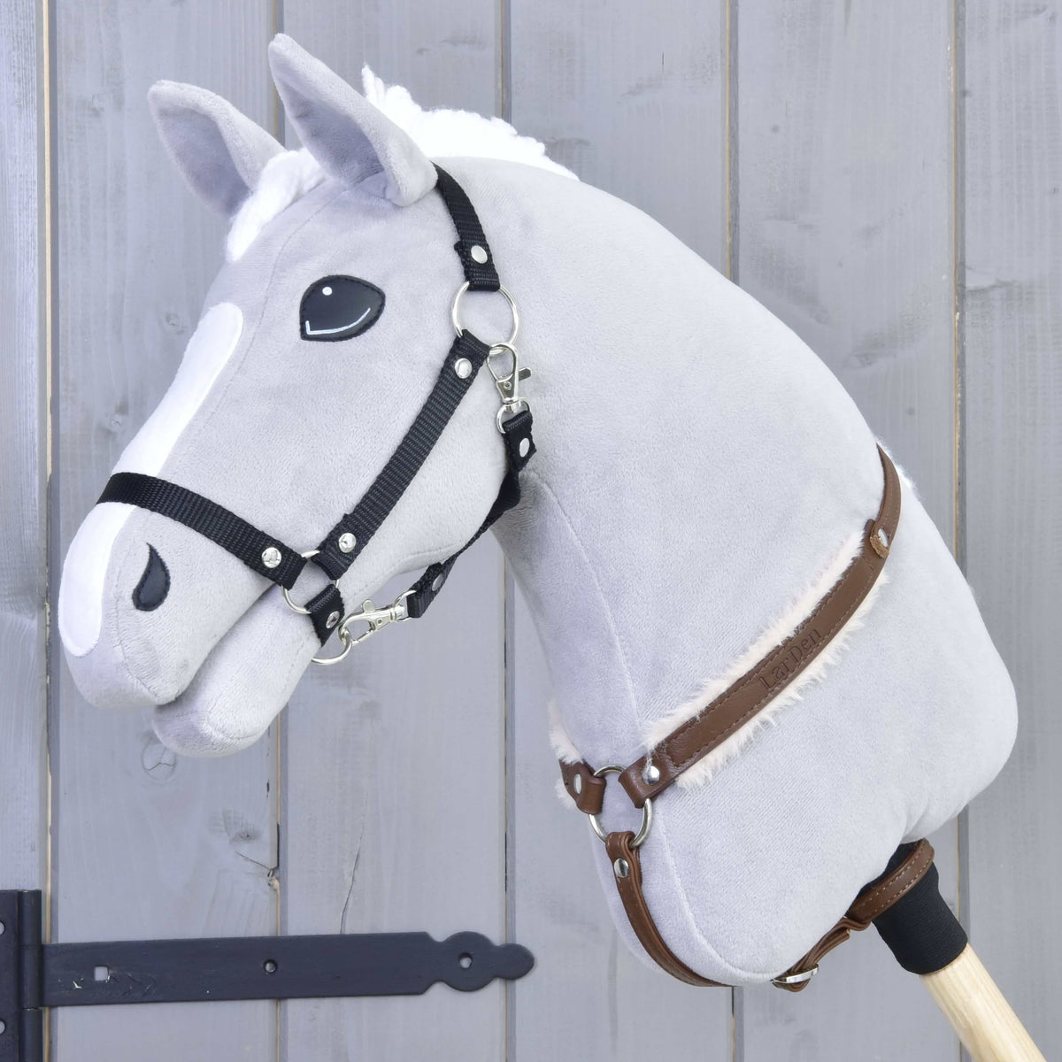 Grey Hobby Horse with a black halter wearing the Breastgirth with fur Walnut in brown leatherette with cream fur