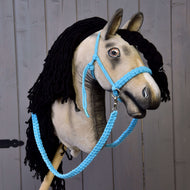 Beige plush Hobby Horse with a black yarn mane wearing the light blue cotton rope halter and braided reins
