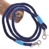 Navy braided rope reins for Hobby Horse with light blue wraps and two silver snap hooks, over a branch